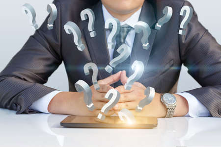 Business man answers questions from the mobile computer.の写真素材