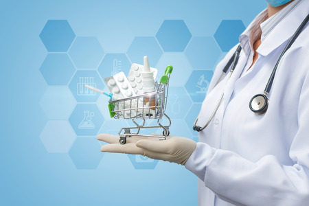 Pharmacist shows the shopping cart with medications. Concept online drugstore.の写真素材