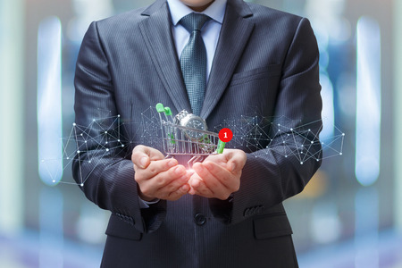 Businessman with a watch in the shopping trolley. Concept shop watches.の写真素材