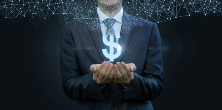 In the hands of a businessman appears the dollar sign from the network connections . The concept of...