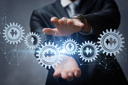 A business man adjusts the control mechanism of employees.