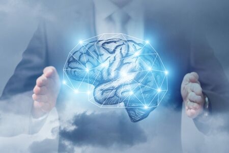 Brain between the hands of a businessman . The concept of brainstorming.