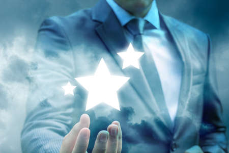 Businessman showing the stars in the sky. The concept of leadership and success.