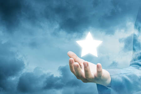 Hand of a businessman showing star.の写真素材