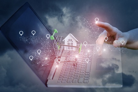 Buying or renting property in the network with a laptop.