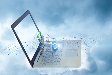 Shopping cart with a house and a shield . The concept of secure buying and selling properties.の写真素材