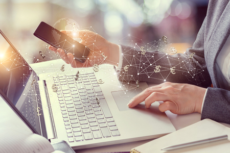 Business woman working in the financial network for mobile devices.の写真素材