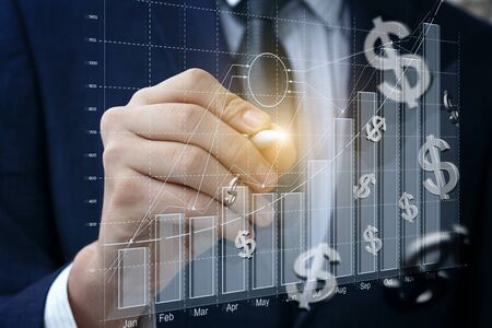 Businessman draws a graph of financial growth closeup.