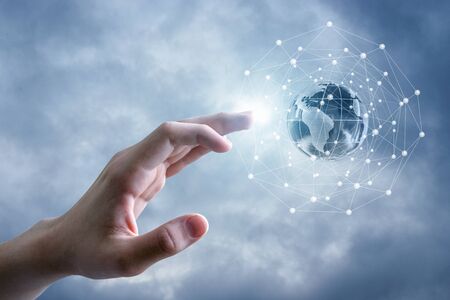 Global network and the hand in the sky.の写真素材