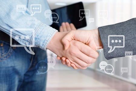Employees shake hands as the result of an agreement.の写真素材