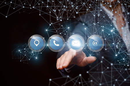 .Businesswoman clicks on the button the mail on a dark background.の写真素材