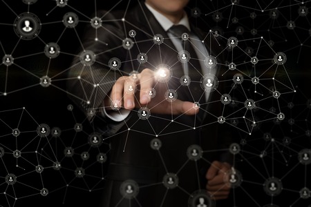 Businessman clicks on the avatar in the network on a dark background.