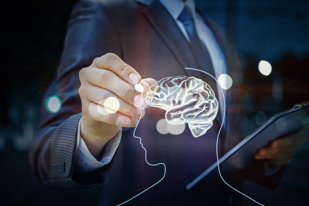 Businessman draws a brain on the virtual screen.の写真素材