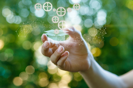 Hand touches the box with the product . The concept of a customizable product.の写真素材