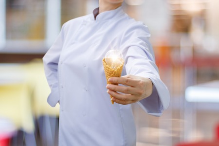 Concept ideas in cooking. Burning light bulb in the hand of the cook.の写真素材