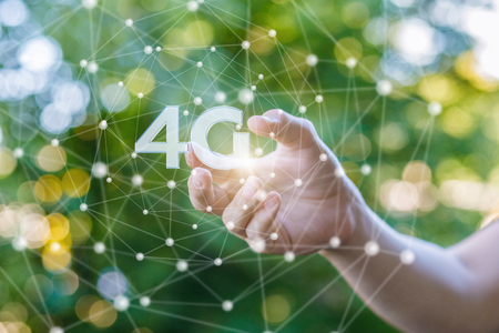 Hand shows the 4g symbol on blurred background.の写真素材