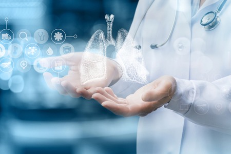 Medical worker shows human lungs on blurred background.の写真素材