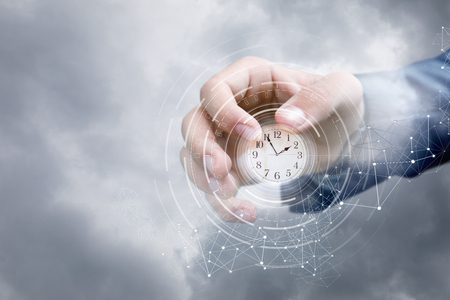 Hand of a businessman in the sky shows the clock . Concept business time .の写真素材