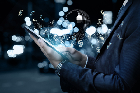 Businessman working in the global financial network on the tablet.の写真素材