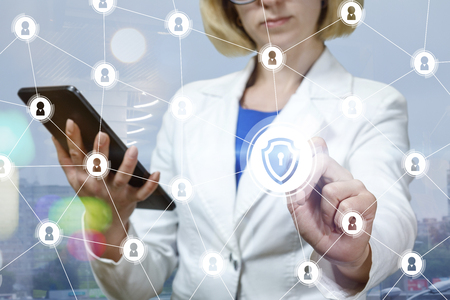 Businesswoman draws a secure network on blurred background.の写真素材