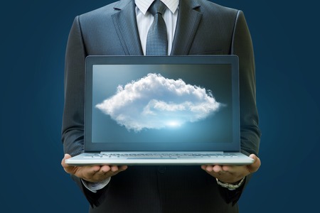 Cloud data in the laptop businessman on a blue background.