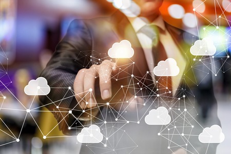 A businessman is operating with the cloud network diagram using the new digital technology. The consept is the innovative Cloud data storage .の写真素材