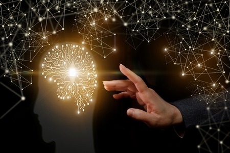 A hand is touching a brain structure consisting of digital lines connected to a card in the middle inside a transparent human head. The concept is the humidity influence on human perception.の写真素材