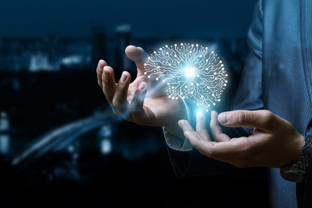 A digital brain model is going up from the businessman 's hands at the busy night city background....