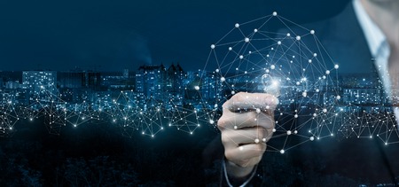 A businesswoman is holding a padlock between her fingers inside a digital connections sphere at the...