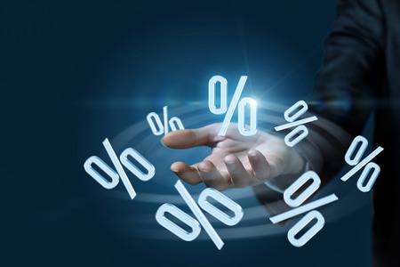 The percents are flying around the businesswoman's hand at the dark background. The concept is...