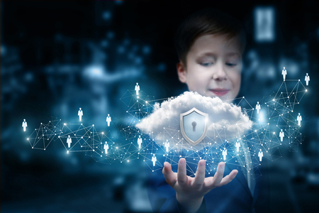 A smiling teenage child is holding a data cloud with shield inside surrounded by wireless...