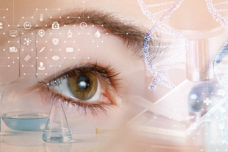 A closeup of a female eye looking straight behind the system of laboratory tools and equipment dna .