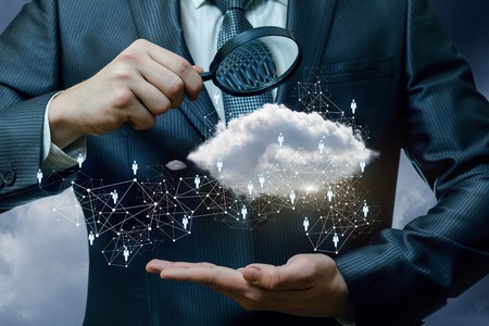 A closeup of a businessman looking at the data and information cloud and human resources structure...
