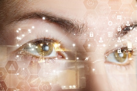 A closeup of a human female eyes with comb cyber security system structure. The concept of data and digital protection and security.