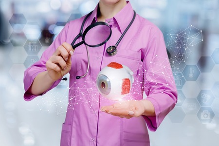 The doctor diagnoses eye on blurred background.の写真素材