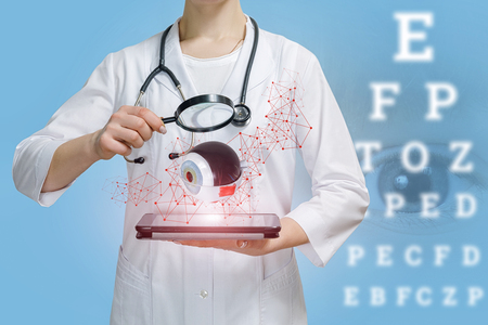 Doctor examines the eye on the blurred background.の写真素材