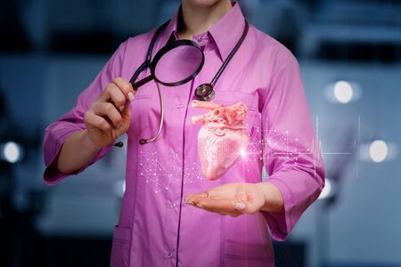 The doctor examines the donor heart on blurred background.の写真素材