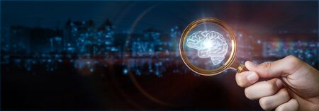 The concept of brainstorming .Man with magnifying glass in hand shows brain.の写真素材
