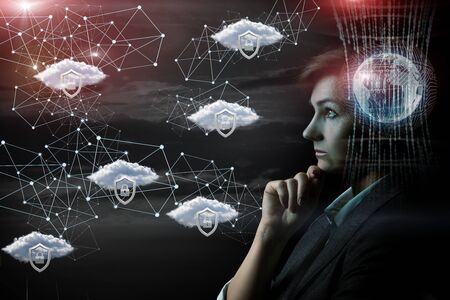 Concept control of the protected network. Businesswoman watching over the network on a dark background.の写真素材
