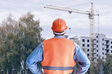The concept of managing construction of the house. Worker stands on building the house.