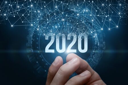 The hand shows the numbers 2020 on a dark background. The concept new 2020 year .の写真素材