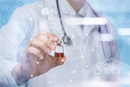 The concept of innovative medicines . Doctor shows a tube of medicine on blurred background.