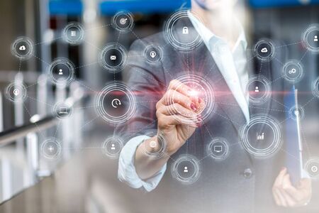 Businesswoman draws a structure of the process integration on blurred background.
