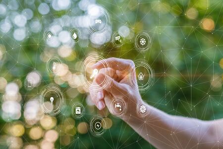 The hand clicks on the key structure of the smart home. The concept of smart home.の写真素材