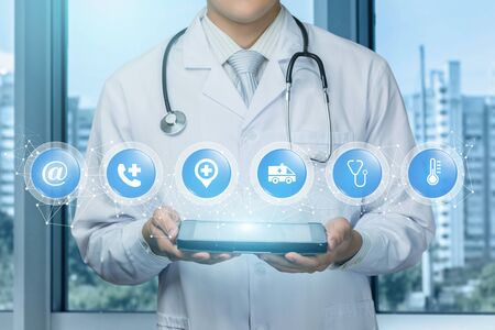 Doctor shows contact icons emergency medical care in network.の写真素材