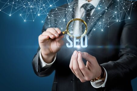 The Concept Of Search Engine Optimization. A businessman looks at emerging from the network of the...