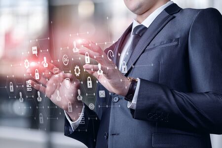 Businessman working on virtual screen with a security system.