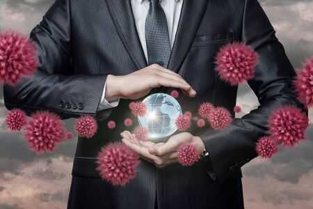The concept of protecting the world from a pandemic epidemic. Businessman protects the world from a pandemic.の写真素材