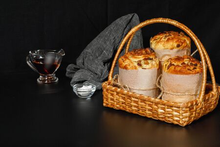 Easter cakes in a basket on a black background.