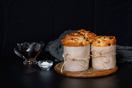 Easter cakes on a wooden board on a black background.